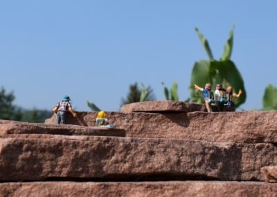 5 tiny figures on a rock