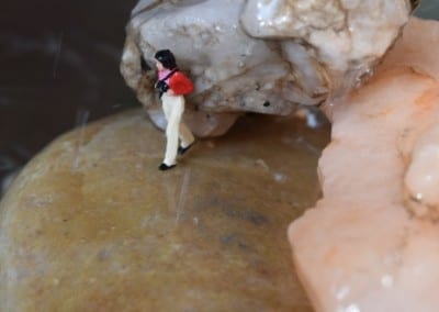 a tiny figure on a rock
