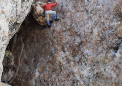 a tiny figure climbing rocks